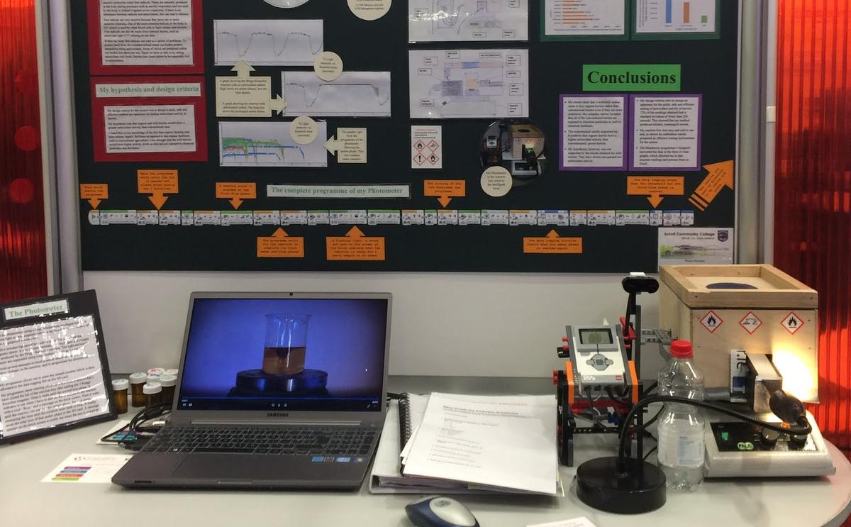 An early science fair stand: a hand-made display board, a plywood box, LEGO Mindstorms and a laptop