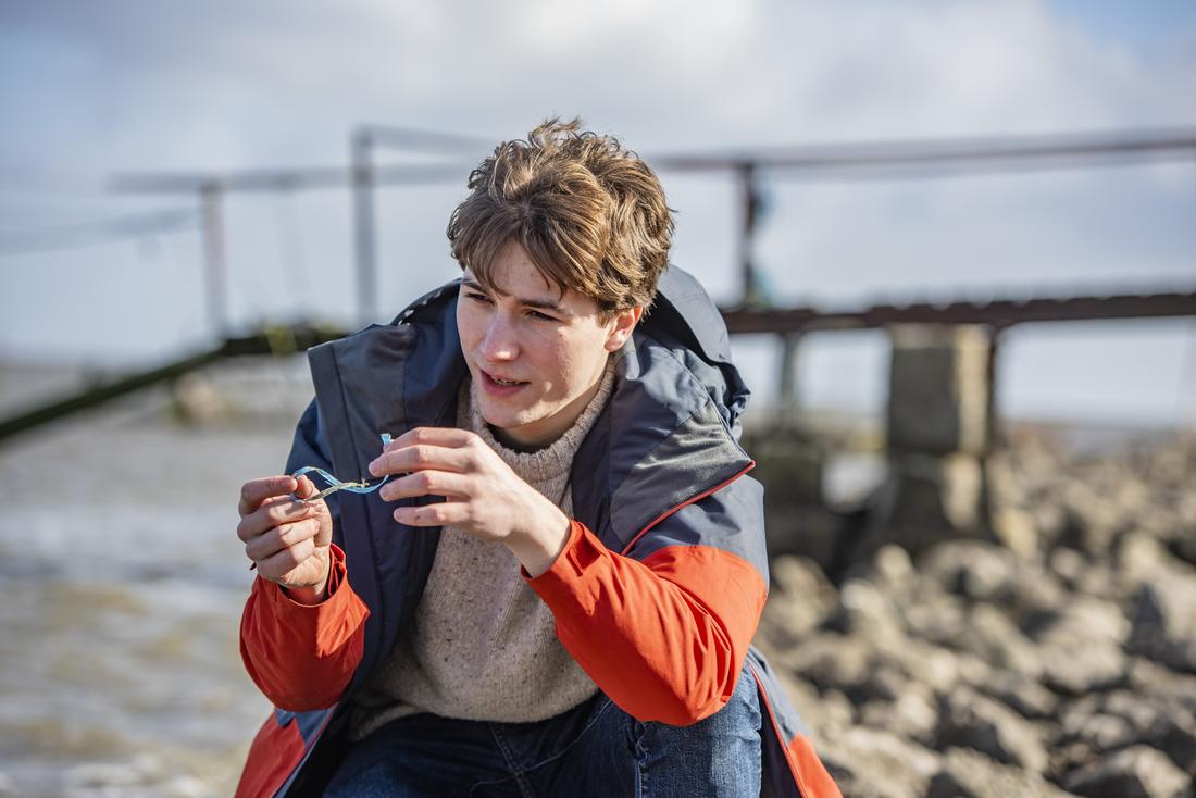Holding a piece of plastic on the shore in West Cork